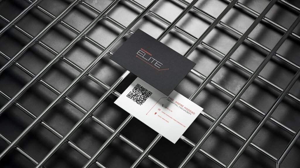 Minimalist Motorworks ELITE business cards on industrial metal grid background, showcasing black and white card design with red and white typography and QR code.