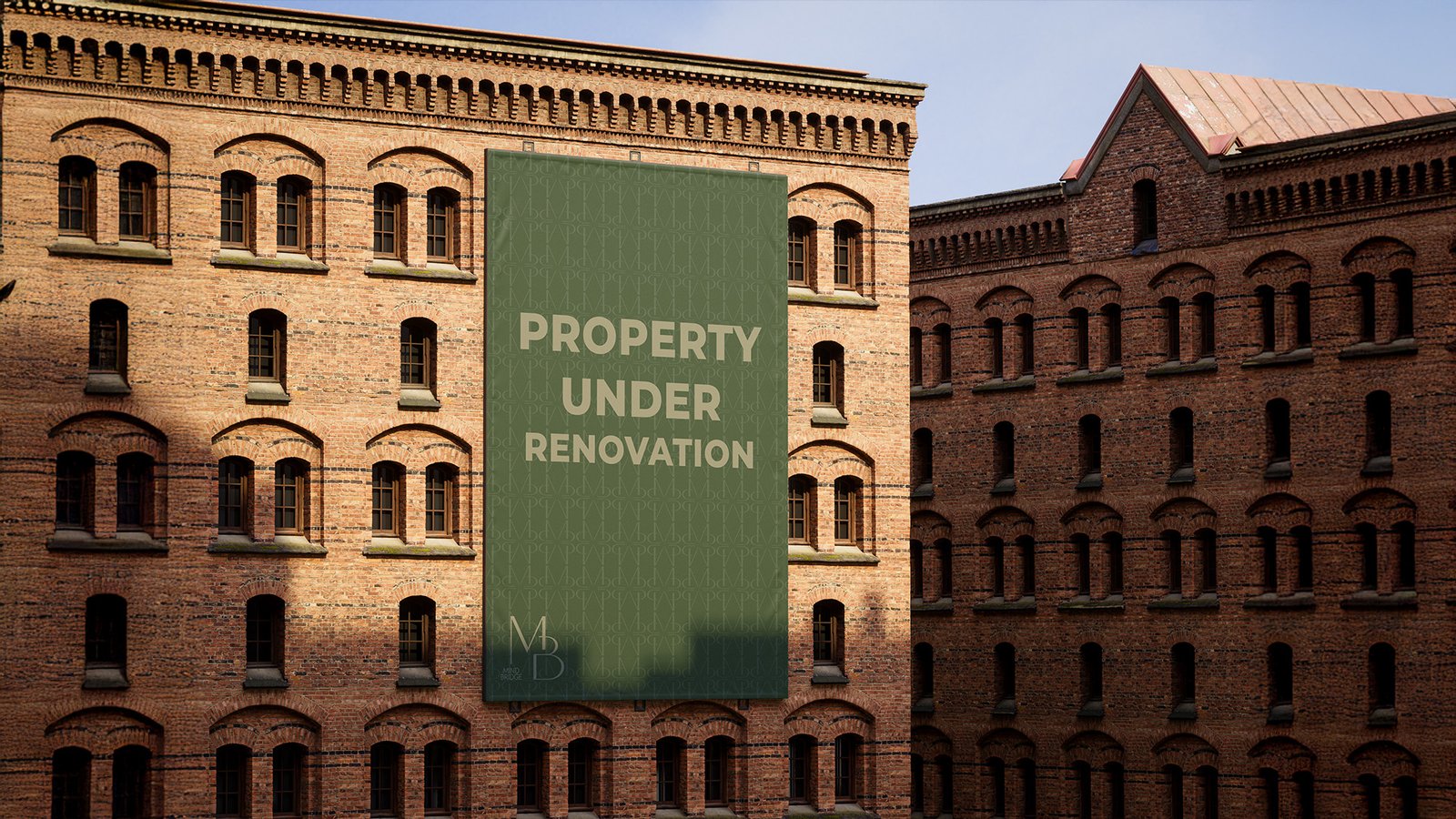 Large green banner with "Property Under Renovation" text displayed on the facade of a historic red-brick building, featuring the Mind Bridge (MB) logo.