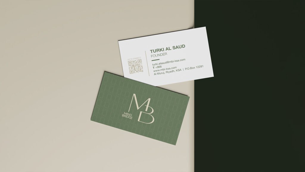 Front and back of a Mind Bridge business card showing the MB monogram on green background and contact details for Turki Al Saud, Founder, on a beige and dark green backdrop.