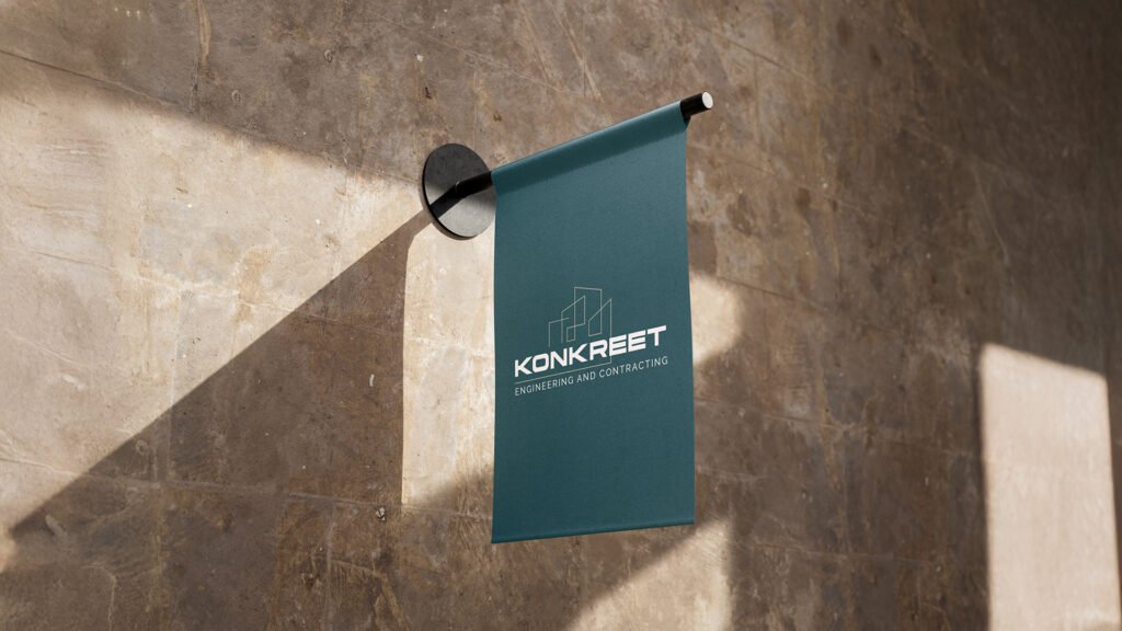 Exterior wall-mounted sign with the Konkrete Engineering and Contracting logo, displayed on a modern building facade in natural daylight.
