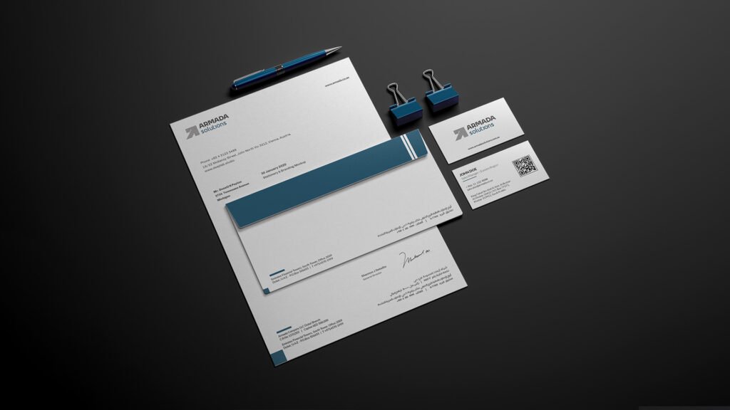 Corporate stationery mockup for Armada Solutions, including letterhead, business cards, envelopes, and branded office accessories on a dark background.