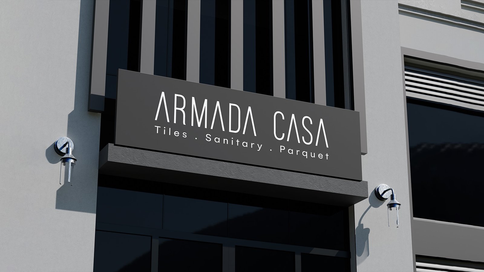 Exterior signage of Armada Casa showroom, displaying the brand name with the tagline “Tiles · Sanitary · Parquet” on a dark background.
